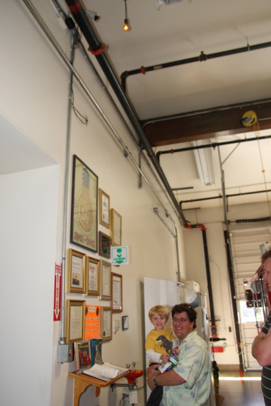 T and C under the Centennial Bulb in a fire station in Livermore, CA. This light bulb has been burning for more than 100 years. We found out about it thanks to Huell Howser, so when our road trip travels brought us through the area in Fall 2010, we had to stop in and see the light.