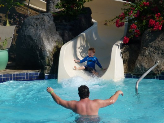 T exits the Kona Pool water slide for the first time on our recent trip to the Hilton Waikoloa Village Resort.