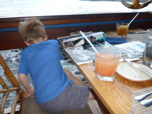 T watching the animals below Huggo's in Kona, HI.