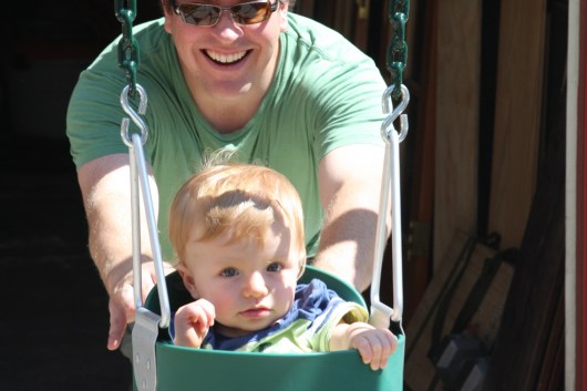 T in the swing for the first time on the driveway as C built it in September 2008. T was just shy of his first birthday.