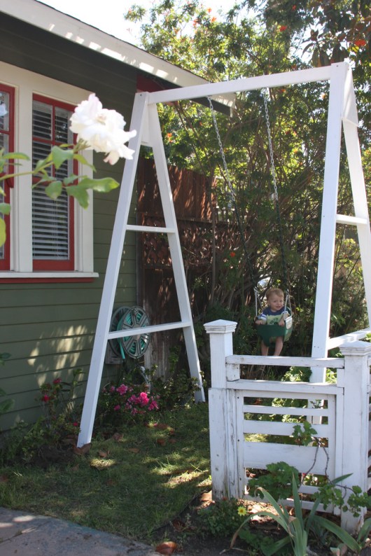 T in the swing after C set it into the front yard September 2008.