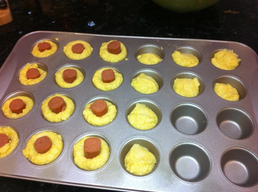Corn Dog Mini-Muffins are as easy as corn bread mix in a mini-muffin tin with a 1" piece of hot dog stuck in center.