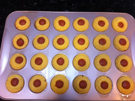 I got a 24-count (vs. 20) count yield from the same Corn Dog Mini-Muffin recipe I tried yesterday. Just redistribute the batter a bit less per cup and cut the hot dogs a little smaller to get five pieces per dog (vs. four).