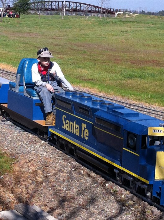 A young club member moves a train from the yard into station during last month's OC Model Engineers' public run. This club is truly for all ages and something the entire family could enjoy together.