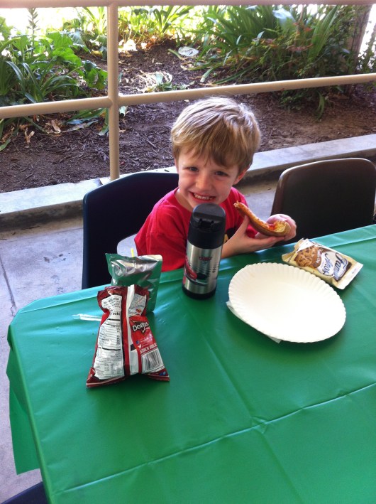 T enjoys his jog-a-thon reward of free dress and a PTA-sponsored pizza lunch! Great work, T!