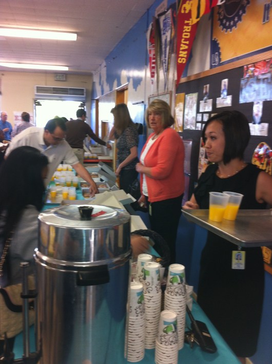 T's teacher (mid-photo) and Principal (L) help distribute the goods on Mom Muffin (Donut) Day last Friday at school.