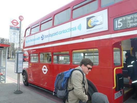 C and T getting on (or off?) one of the older Routemaster buses that runs along the 15 line in London. Passengers board and leave through the back door, making it such that there has to be a second employee other than just a driver to make sure no one gets a free ride!