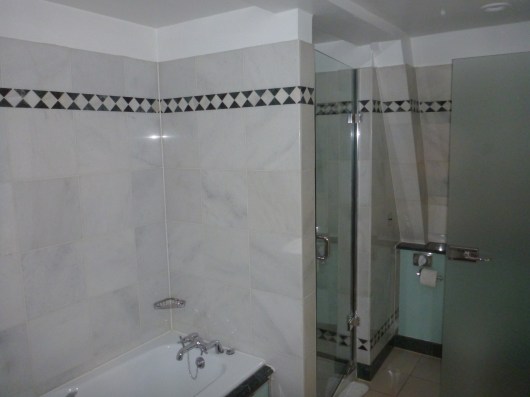 Tub and shower in the executive room at The Waldorf Hilton, London.