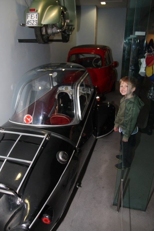 T with one of the model cars inside of Science Museum, London.