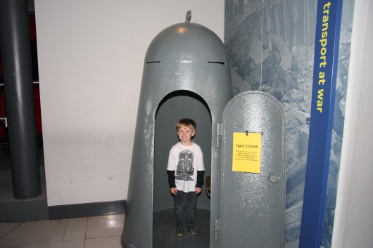 T stands inside of a former WWII bomb shelter. The London Transport Museum has quite the exhibit dedicated to its role during the War. Yes, buses and the Underground operated during most of the War. The tunnels also offered shelter during times of need.