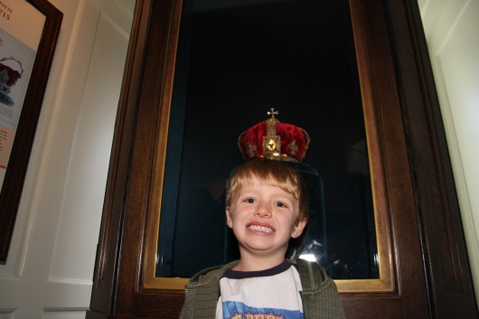 T gets crowned in a nearby exhibit that has a few replica jewels and crowns on display at the Tower of London. This is not part of the official Crown Jewels vaults.