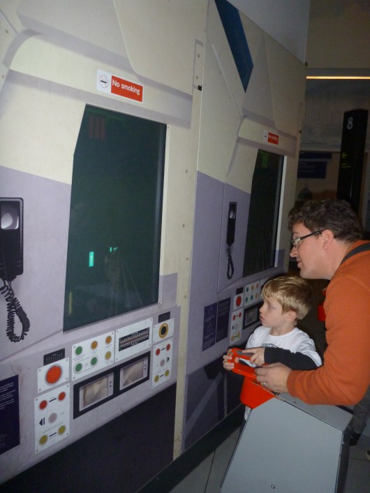 The boys working another of the driving simulation games at the London Transport Museum.
