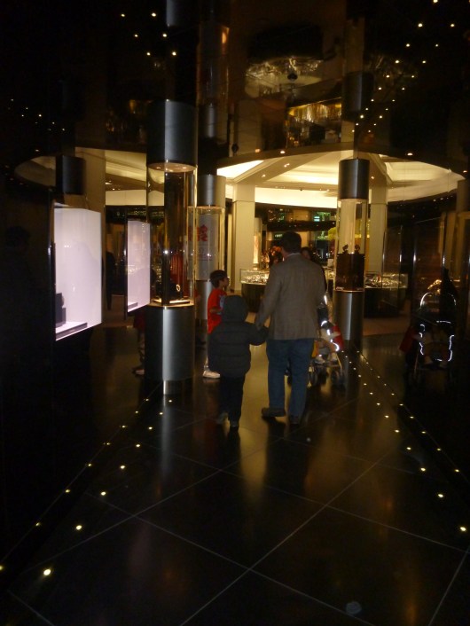T and C walk through one of the fine jewelry halls at Harrods.