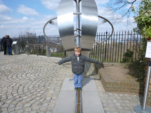 T straddling the Prime Meridian at Royal Observatory, Greenwich.