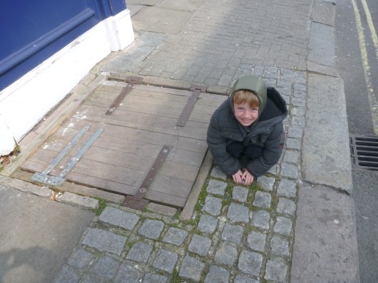T taking a shopping break to... pick grass outside of The Tea Clipper.