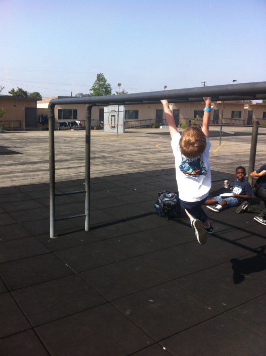 T's first time across the monkey bars was on the school playground during carnival. Yay!