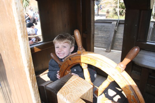 T steers the big pirate ship at the Diana, Princess of Wales' Memorial Playground in London's Kensington Gardens.