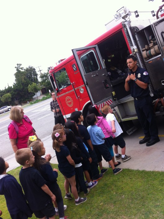 The kids line up for their chance to get on board the fire engine at Station 22 during their field trip.