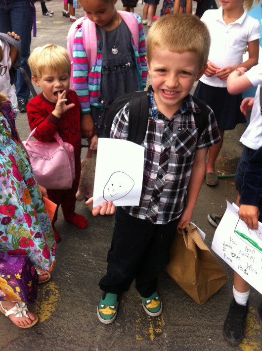 T on his last day of TK holding a card for his beloved teacher, Mrs. Willson.