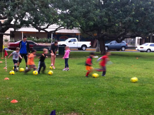 Week one of soccer for T! Here they are racing to the different colored posts on the edge around the field to practice kicking and running skills.