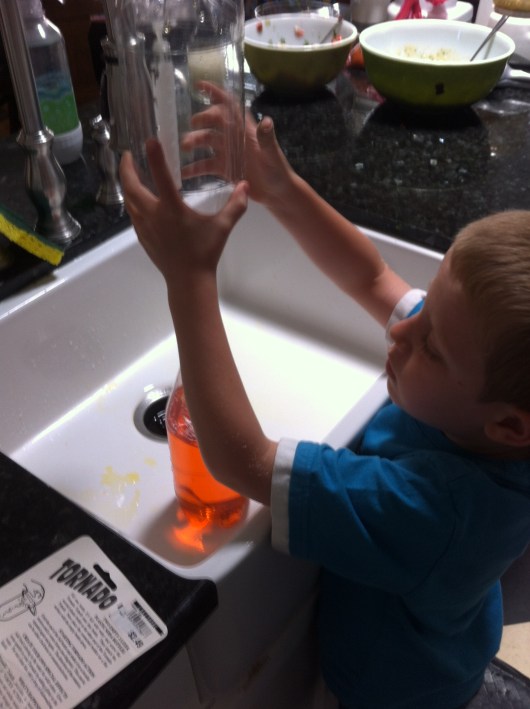 T gets ready to flip the tornado over and get it started.