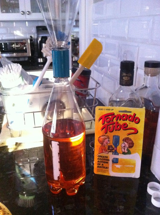 Tornado Tube is the greenish-blue gizmo holding these two 1-liter bottles together.