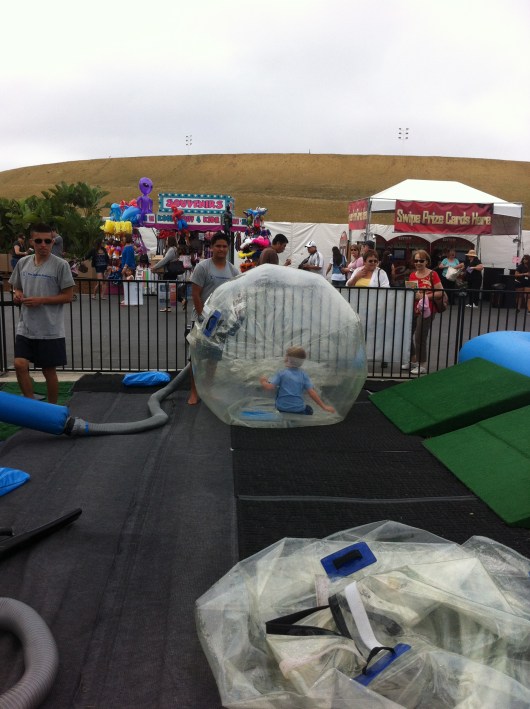 The Bubble Rollers inflate T's hamster ball at the OC Fair.