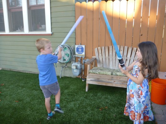Impromptu lightsaber battles is what having a neighbor kid friend is all about.
