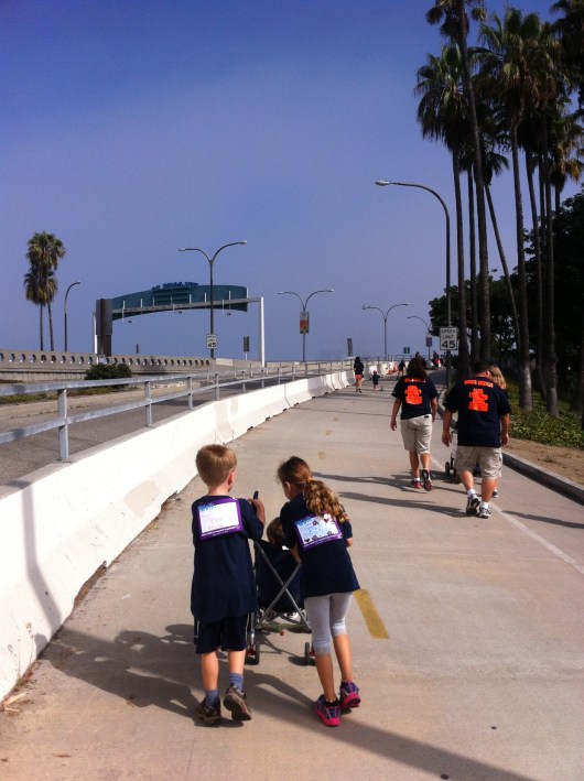 T and his friend cooperating to push their other friend in a stroller during the iWalk.