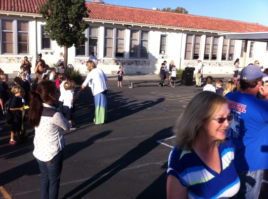 T waiting for the assembly to start and waiting for the other classroom appointees to join him up front.