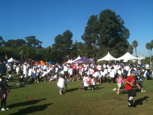 Walkers of all ages and abilities warming up during last year's iWalk... for Kids.