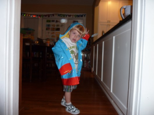A very fashionable three-year-old T showing off one of his presents post-party.