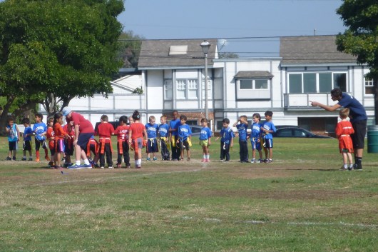 Their team had 14 players, ours a mere eight. Thankfully it's just flag football, but still they could have rotated a few of those kids in and out to make it a more man-on-man than two-on-one.