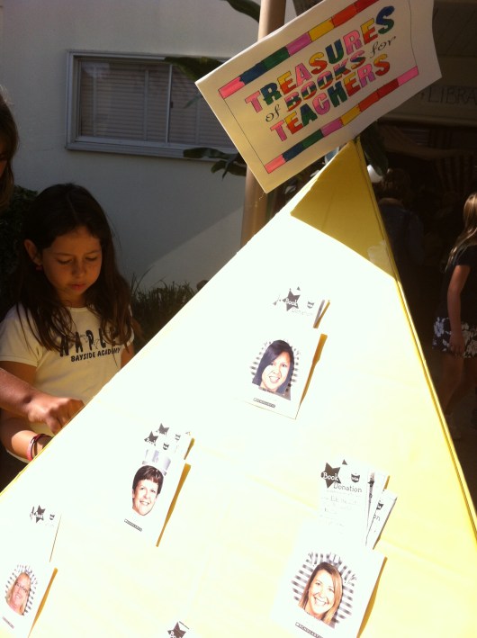 The Pyramid of Books, a wish tower for teachers at T's school, allowed shoppers to take a ticket or two and buy books for their children's classrooms.