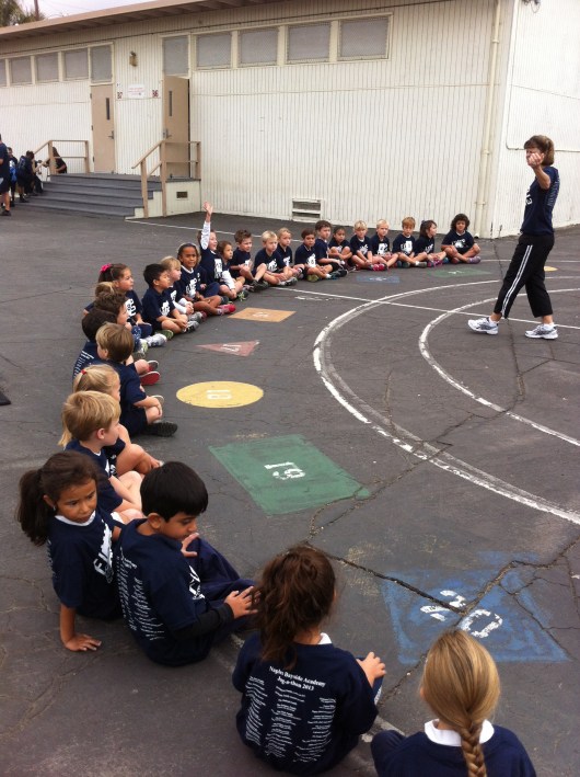 Mrs. K warms up the class with an explanation of how a jog-a-thon runs.