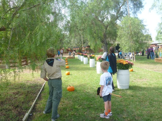 T ponies up for a ride around the hobby horse track at the Harvest Festival at Rancho Los Alamitos.