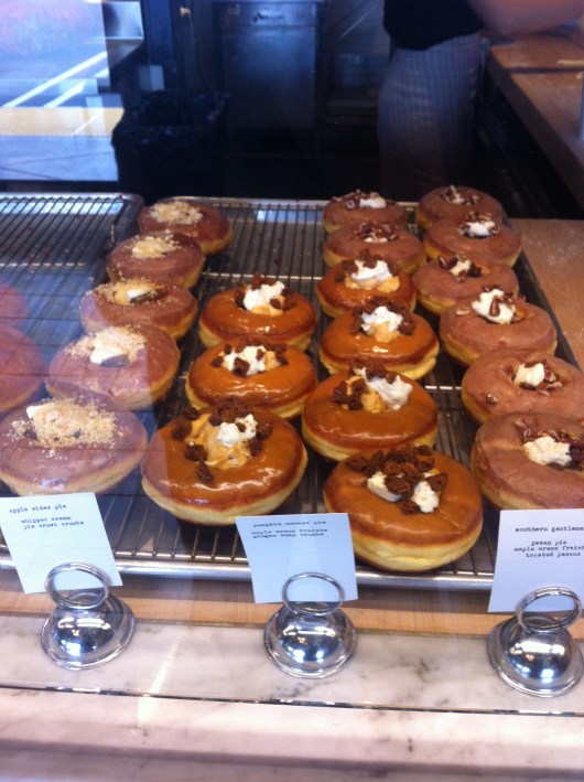 Three pie-style doughnuts waiting for friends to take them home. Trust me, from the line I waited in, they won't be waiting long!