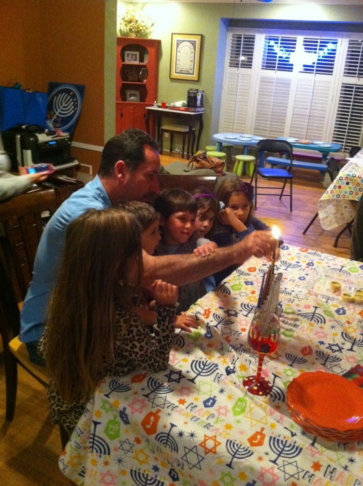 Our friend helped the kids light the Menorah on Night Five during a small Hanukkah gathering at their home. 