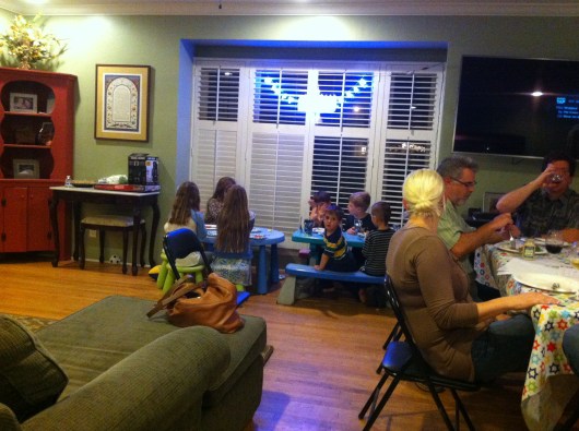 The kids are sitting and eating. This was the only time they sat down.