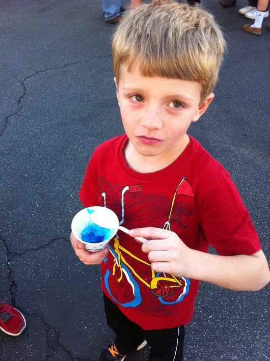 T enjoying a snow cone. As in, "Mom, stop taking pictures of me eating this snow cone."