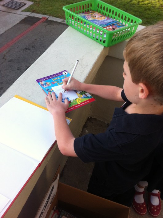 T fills out his book-plate for his Milk + Bookies donation.