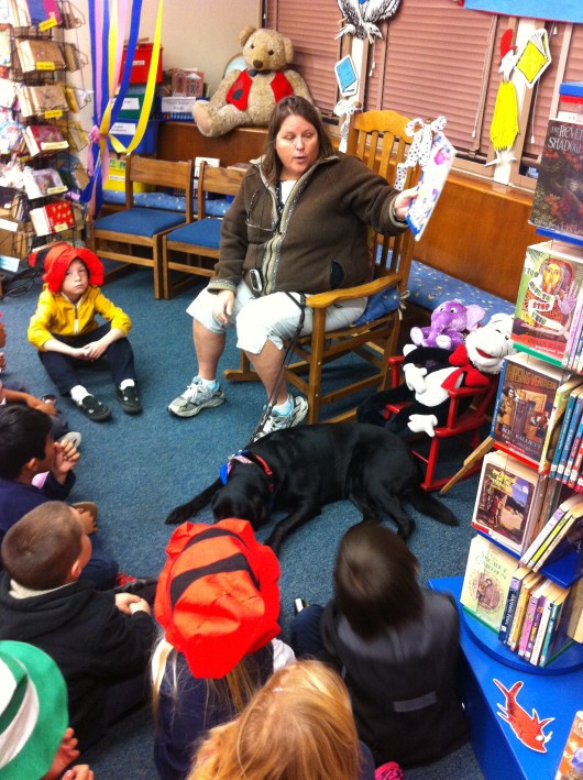 A BARK volunteer human and her volunteer pup read at our school as part of our Read Across America events.