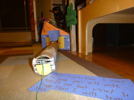 The note says, "Dear Leprechaun, I want to trade your gold with me. If you don't trade with me I will trap you."