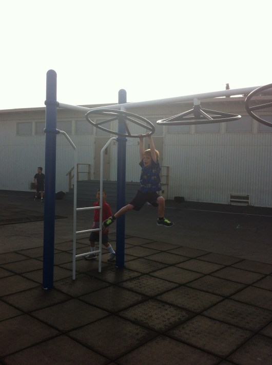 This morning T tried on the "grader" playground equipment. You can do anything, T.