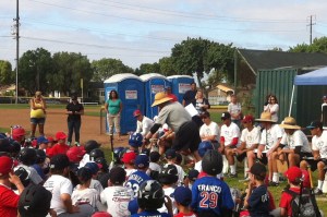 Grandpa explains that touching another player other than a high-five is not OK. He models this by showing that tapping another player on the helmet is not OK behavior.